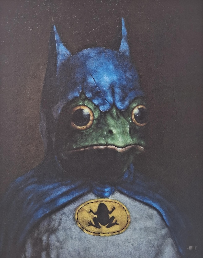May include: A painting of a frog wearing a blue and gray costume with a cape and a bat-like cowl. The frog has large, round eyes and a green face. A gold emblem with a frog silhouette is on the chest.