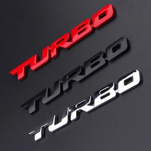 May include: Three "TURBO" emblems in different colors: red, black, and silver. The emblems are made of metal and have a raised 3D design.