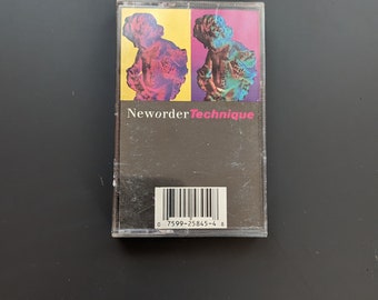 May include: A cassette tape with a black background and a barcode. The front of the tape features a colorful image of two figures with a yellow, pink, and blue color scheme. The text "Neworder Technique" is printed in white on the tape.