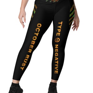 May include: Black leggings with a yellow and green stripe down the side. The leggings have the text "TYPE O NEGATIVE" and "OCTOBER RUST" printed on them.