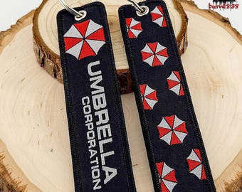 Llavero de Umbrella Corp. de Resident Evil – Logotipo y nombre bordados, producto de la película, envío gratis.