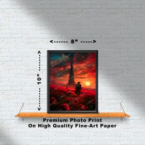 Puede incluir: Una impresi&oacute;n enmarcada de un paisaje de fantas&iacute;a con una alta torre oscura en la distancia. Una figura solitaria con un abrigo largo camina hacia la torre, con una puesta de sol roja en el fondo. La impresi&oacute;n mide 20,3 cm de ancho y 25,4 cm de alto.