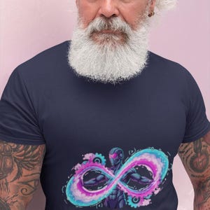 May include: A navy blue short-sleeved t-shirt featuring a graphic print of a futuristic figure centered within a glowing pink and blue infinity symbol, with mechanical gears and the text "DevOps Warrior" printed in pink below the design.