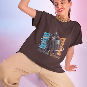 May include: A dark brown t-shirt featuring a graphic of a knight in armor holding a shield, flanked by glowing blue and orange pillars. The text "DATABASE WARRIOR" is printed in a stylized font below the knight, set against a solid background.