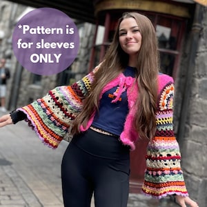 May include: A woman wearing a pink crocheted top with a blue shirt underneath and black pants. The top has a colorful crocheted trim around the sleeves. The text "*Pattern is for sleeves ONLY" is visible in the image.