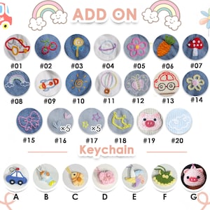May include: A selection of 20 embroidered denim patches with various designs, including a rainbow, a rocket ship, a sun, a hot air balloon, a butterfly, a car, a flower, a bow, a heart, a star, a crescent moon, a pig, and a cloud. The patches are numbered 1 through 20. Below the patches are 7 crocheted keychain charms with various designs, including a car, a fish, a butterfly, a flower, a pinwheel, a dress, and a pig. The charms are labeled A through G.