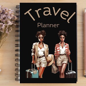 May include: A black travel planner notebook with a gold title that reads "Travel Planner". Two women with dark skin are illustrated on the cover, each carrying a suitcase and wearing sunglasses. One woman is wearing a tan jacket and white shorts, the other is wearing a red and white striped jacket and white shorts.
