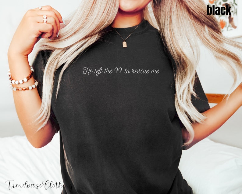 May include: A black t-shirt with the text "He left the 99 to rescue me" in white lettering.