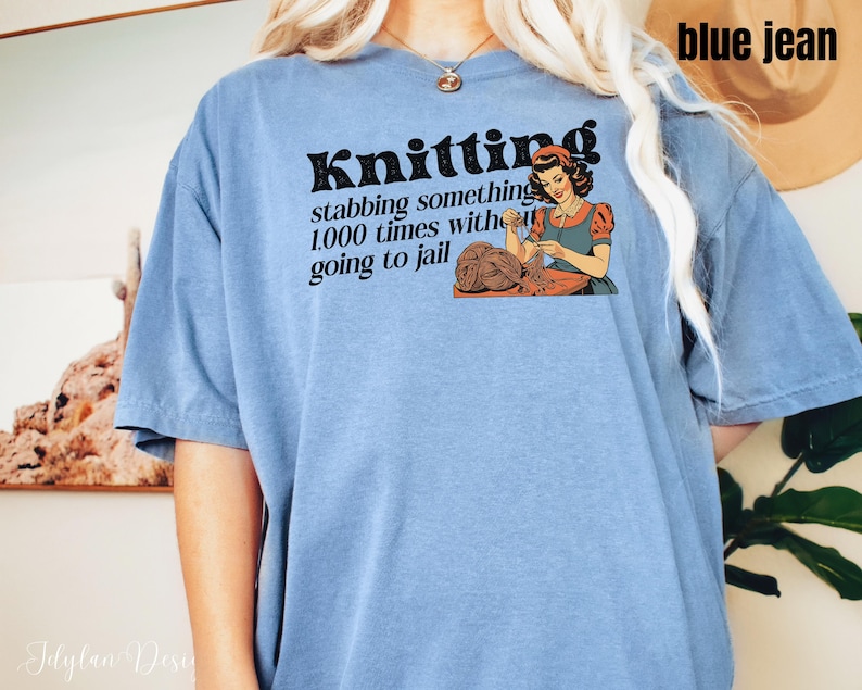 May include: A blue jean t-shirt with the text "Knitting: stabbing something 1,000 times without going to jail" and a retro illustration of a woman knitting.
