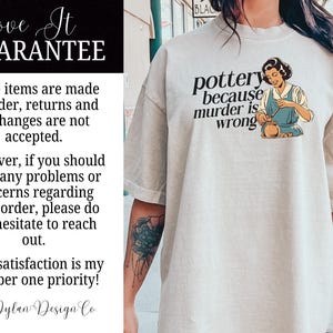 May include: A light gray t-shirt with a graphic of a woman making pottery. The text on the shirt reads "pottery because murder is wrong".