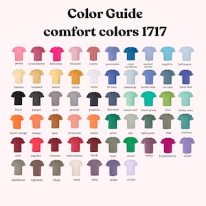 May include: Color guide for Comfort Colors 1717 t-shirts. The image displays a grid of t-shirts in various colors, including peony, black, burnt orange, chili, and sandstone. The text "Color Guide" and "comfort colors 1717" are at the top.