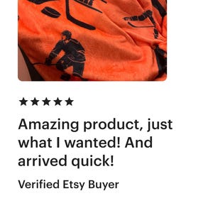 May include: Orange fleece blanket with a black hockey player design. The blanket features the number "68" and the name "Spencer" printed on it.