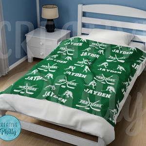 May include: Green and white fleece blanket with a hockey player and stick design. The blanket features the name "Jayden" and the words "Panthers" repeated throughout.