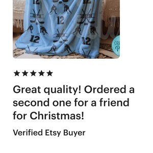 May include: A light blue fleece blanket with a hockey player and stick design. The blanket is personalized with the name "Justin" and the number "12".