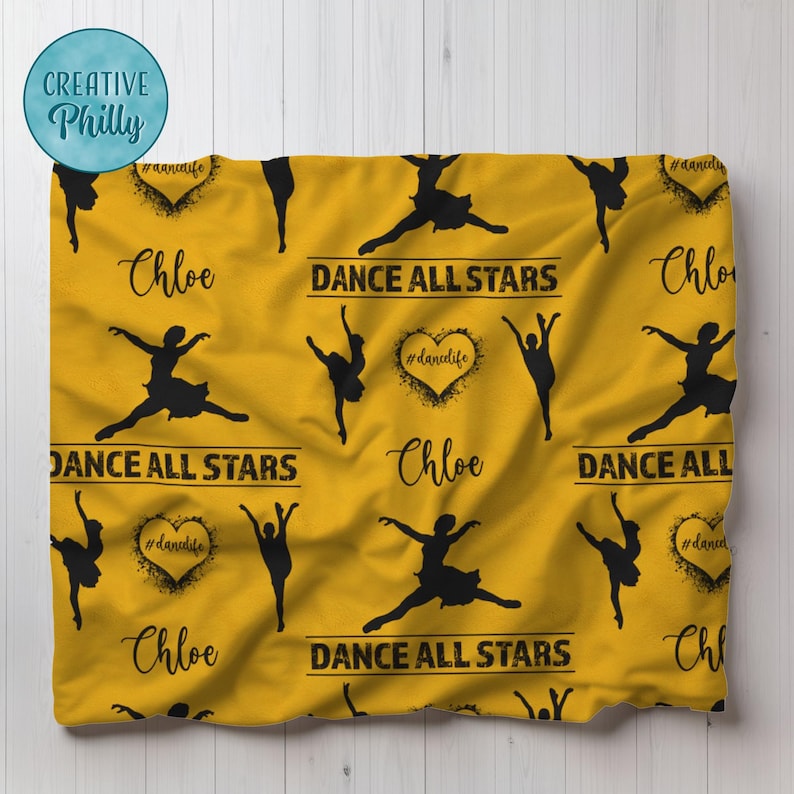 May include: Yellow fleece blanket with a black and white pattern of dancers and the text "DANCE ALL STARS" repeated throughout. The name "Chloe" is also repeated throughout the blanket.