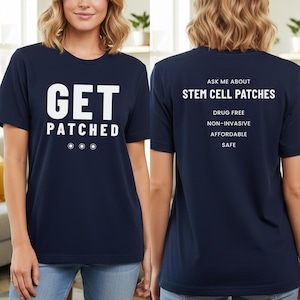 May include: A navy blue t-shirt featuring the text "GET PATCHED" in white on the front. The back of the shirt displays "ASK ME ABOUT STEM CELL PATCHES" along with the phrases "DRUG FREE, NON-INVASIVE, AFFORDABLE, SAFE."