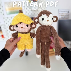 Puede incluir: Dos muñecos de mono de ganchillo. Uno es marrón con detalles blancos, el otro lleva un gorro y un peto amarillos con forma de plátano. El texto "PATTERN PDF" y "Greta & George" se muestran en el fondo.