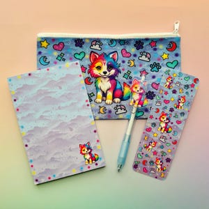 May include: A stationery set featuring a colorful wolf design. The set includes a pencil case, notepad, pen, and bookmark. The pencil case and bookmark have a blue background with hearts, stars, and paw prints. The pen has a wolf topper.