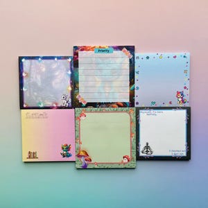 May include: A collection of six square sticky notes with colorful designs. The notes feature illustrations of mushrooms, cats, and other whimsical elements. Some notes have text that reads "Priority", "Physically, I'm here. Mentally," and "I checked out 3 days ago."