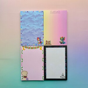 May include: A white ceramic mug with a black handle and the text "But First, Coffee" in a bold, black font. The mug is set against a blurred background, suggesting a cozy setting.