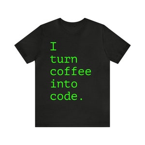 May include: Black t-shirt with the text "I turn coffee into code" in bright green, a humorous statement for programmers. The shirt is a short-sleeved crew neck.