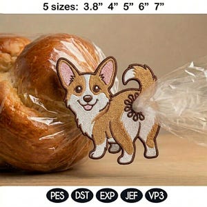 May include: Embroidered patch featuring a smiling corgi dog in shades of brown, white, and tan. The patch is available in five sizes, ranging from 3.8" to 7". The patch is shown attached to a clear plastic bag. The bottom of the image shows the file formats.