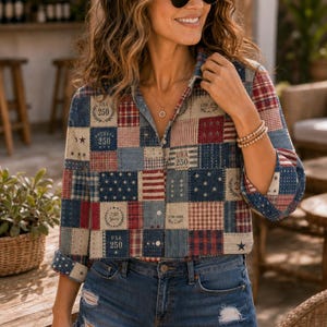 May include: A patchwork button-down shirt with red, white, and blue squares, stars, and stripes. The shirt has rolled-up sleeves and is paired with denim shorts. The shirt features the text "USA 250" on several patches.