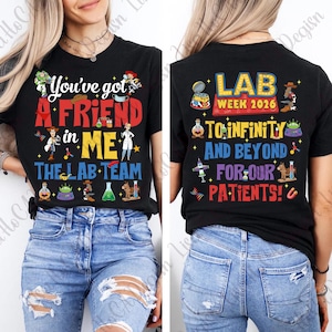 May include: Black t-shirt with colorful text and graphics. The front reads "You've got A FRIEND in ME" with cartoon characters and "THE LAB TEAM." The back says "LAB WEEK 2026" and "TO INFINITY AND BEYOND FOR OUR PATIENTS!"