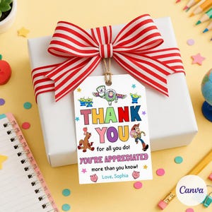 May include: A white gift box with a red and white striped bow. A gift tag with the text "THANK YOU" and Toy Story characters is attached. The tag also includes the phrases "for all you do!" and "YOU'RE APPRECIATED".