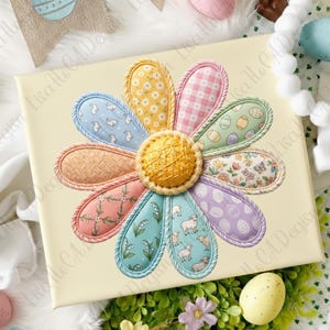 May include: A canvas art piece featuring a large, colorful flower design. The flower petals are various pastel colors with different patterns, including bunnies, eggs, and floral prints. The center of the flower is a textured yellow circle.