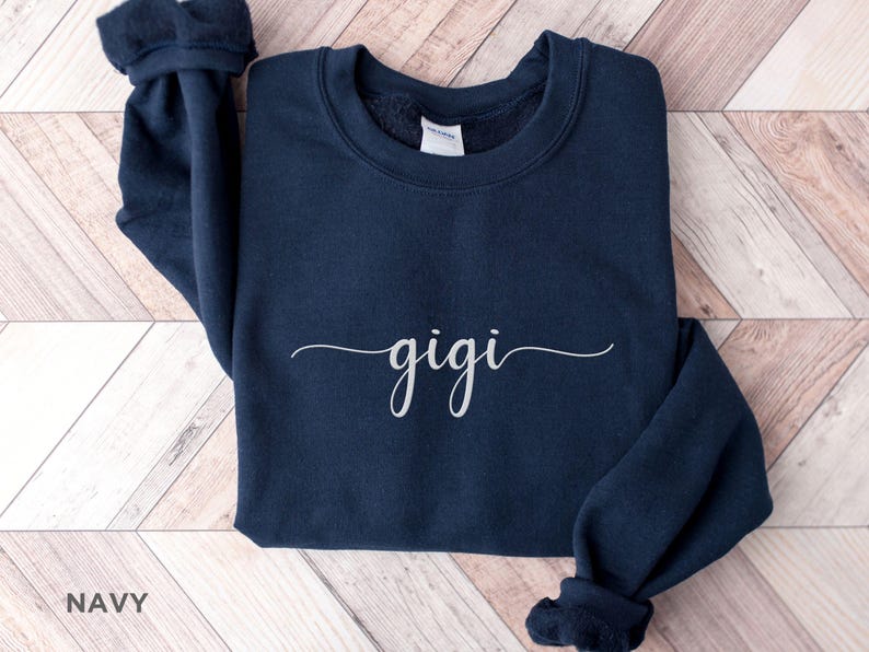 May include: Navy blue sweatshirt with the word "gigi" written in white cursive script.