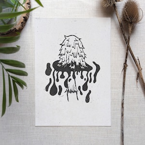 May include: Black and white linocut print of a fuzzy, round creature with dripping black ink around it.