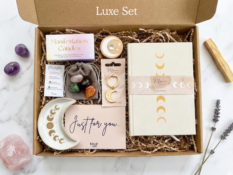 Manifestation gift set in size luxe - a spiritual gift that comes gift wrapped and includes manifestation candles, a set of four healing crystals, spell candle holder, crescent moon keyring and moon phases trinket dish