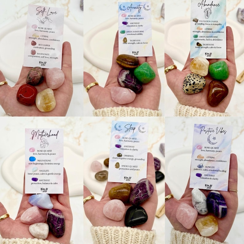 May include: Six sets of polished tumbled gemstones, each accompanied by a descriptive card labeled with themes like Self Love, Anxiety, Abundance, Motherhood, Sleep, and Positive Vibes, detailing specific stone names and their properties.