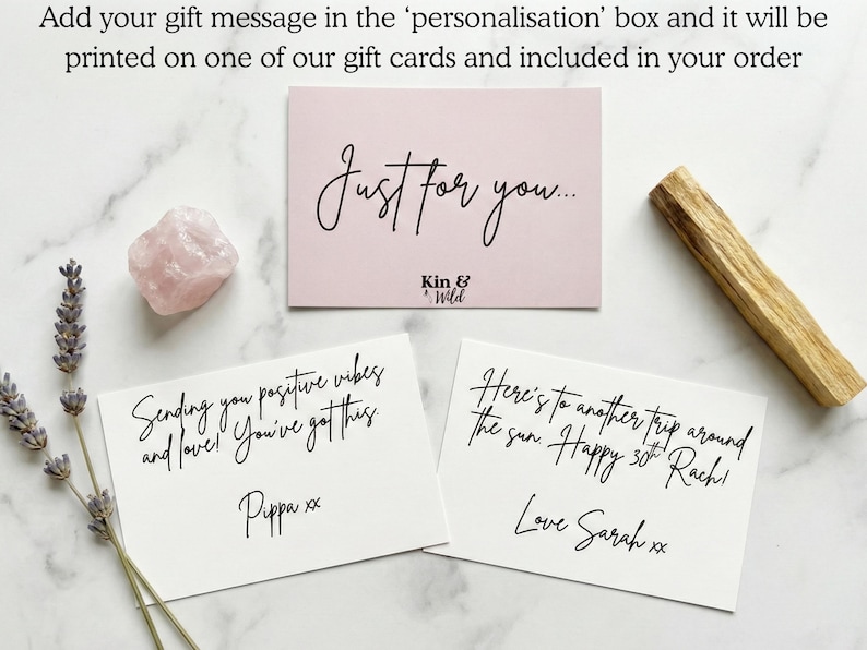 May include: Three rectangular gift cards with black cursive text, a pale pink rose quartz crystal, and a dried lavender sprig. One card reads Just for you... Kin & Wild, another says Sending you positive vibes and love! You've got this. Pippa xx, and the third reads Here's to another trip around the sun. Happy 30th Rach! Love Sarah xx.