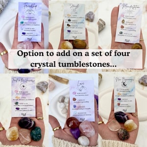 May include: A set of crystal tumblestones with informational cards. The cards feature the words "Friendship", "Strength", "Manifestation", "Trust in the Universe", "Love", and "New Beginnings". Each card lists the crystals and their properties.