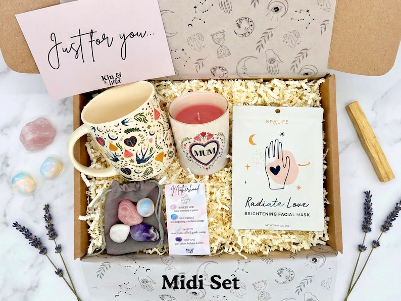 May include: A gift box with a floral mug, a candle with "MUM" in a heart, a facial mask, crystals, and a card that says "Just for you...". The box is labeled "Midi Set".
