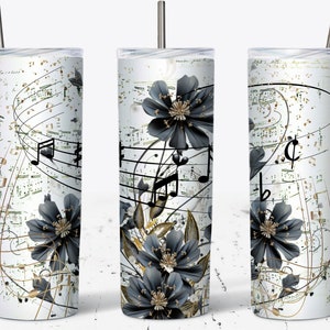 May include: A white tumbler with a black and gold floral design and musical notes. The tumbler has a straw and is ideal for holding drinks.