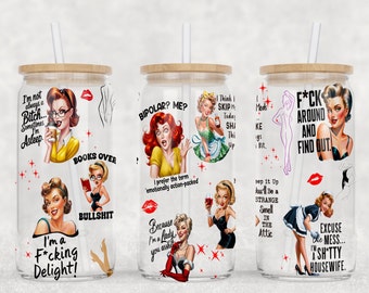 May include: Three clear glass tumblers with bamboo lids and straws. Each tumbler features a different design with a vintage pin-up girl and a humorous saying. The first tumbler says "I'm not always a Bitch... Sometimes I'm Asleep" and "I'm a F*cking Delight!" The second tumbler says "BIPOLAR? ME? I prefer the term 'emotionally action-packed'" and "Because I'm a Lady, you asked". The third tumbler says "Think I SKIP Meds Today? SHA KE Thi Up I Bit." and "F*CK AROUND AND FIND OUT." and "sep it Up Jou'll Be a STRANGE Smell IN THE Attic" and "EXCUSE the MESS... I'm a SHTTY HOUSEWIFE."