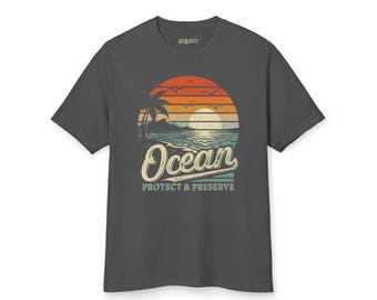 May include: A dark gray t-shirt with a vintage-style graphic of a sunset over the ocean. The graphic includes a palm tree, a sun, and the words "Ocean Protect & Preserve".