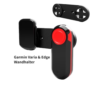 Puede incluir: Soporte de bicicleta negro con un botón rojo y una pantalla negra. El soporte está etiquetado como "Garmin Varia & Edge Wandhalter".
