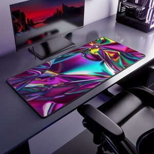 May include: A large, colorful, iridescent desk mat with a wavy, abstract design. The mat is on a desk with a computer monitor and a chair.