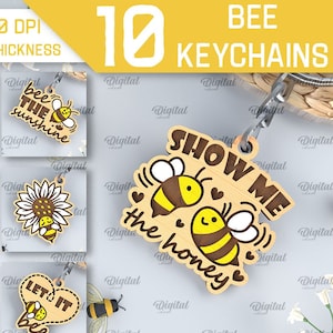 Può includere: Dieci portachiavi a tema ape con diversi design e detti. I portachiavi sono in legno e presentano una varietà di immagini e testi legati alle api, come "Benvenuti nel nostro alveare", "Dolce come il miele", "Sii il sole", "Sii semplicemente te stesso", "Mostrami il miele", "Sii sempre gentile", "Sii felice", e "Lascia che sia".