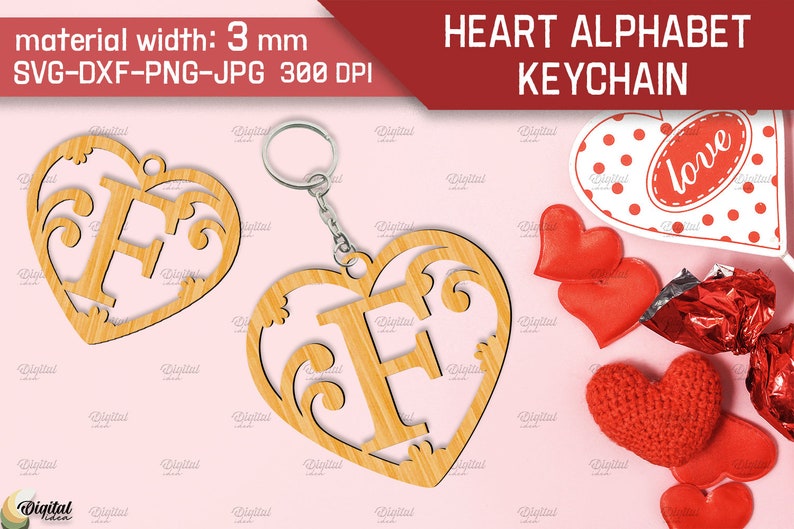 May include: A wooden heart-shaped keychain with a decorative letter F cut out. The keychain is made of light brown wood and has a silver key ring attached. The background is pink.