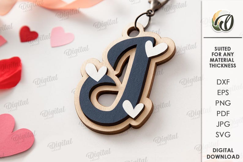 May include: Wooden letter "J" keychain with a navy blue center and light wood border, adorned with white heart accents. The keychain is attached to a metal clasp. The image also includes heart-shaped cutouts and the text "SUITED FOR ANY MATERIAL THICKNESS".