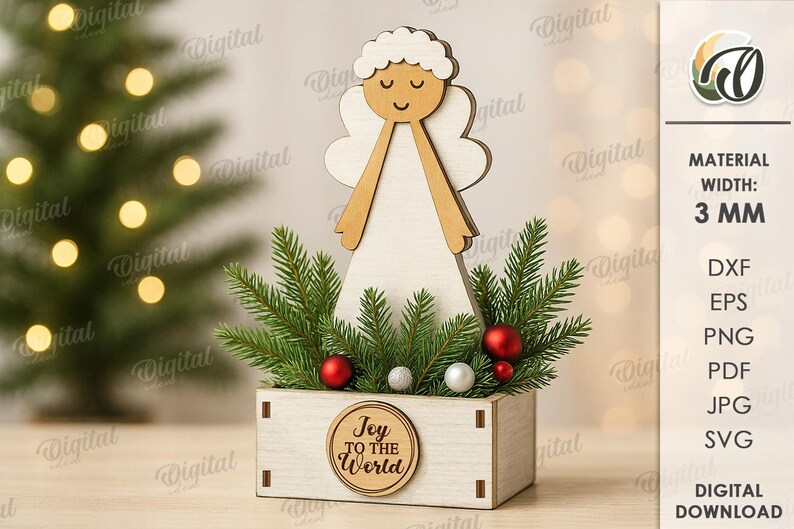 May include: A wooden Christmas angel decoration with a light wood body and wings, and a smiling face. The angel is set in a small wooden box with greenery, red and silver ornaments, and the text "Joy to the World".
