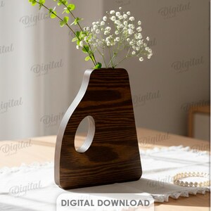 K&ouml;nnte beinhalten: Eine dunkelbraune Holzvase mit einem einzigartigen griffartigen Ausschnitt, in der gr&uuml;ne Stiele und wei&szlig;e Bl&uuml;ten stehen. Die Vase steht auf einem wei&szlig;en Spitzentischl&auml;ufer. Der Text "DIGITAL DOWNLOAD" ist ebenfalls enthalten.