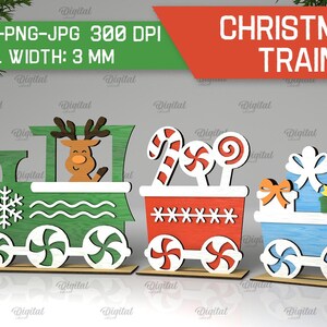 May include: A Christmas train with three cars. The first car is green and features a reindeer, the second car is red and has candy canes, and the third car is blue and has presents. The train is made of wood and is ready to be cut out and assembled.