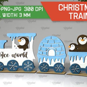May include: A Christmas train with three cars, each decorated with a penguin and snowflakes. The first car is a blue and white engine with the words "Ice World" on the side. The second car is a blue and white igloo. The third car has three penguins on board.