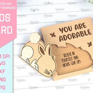May include: A wooden card with a bunny cutout and the text "You are adorable. Believe in yourself and never give up!"